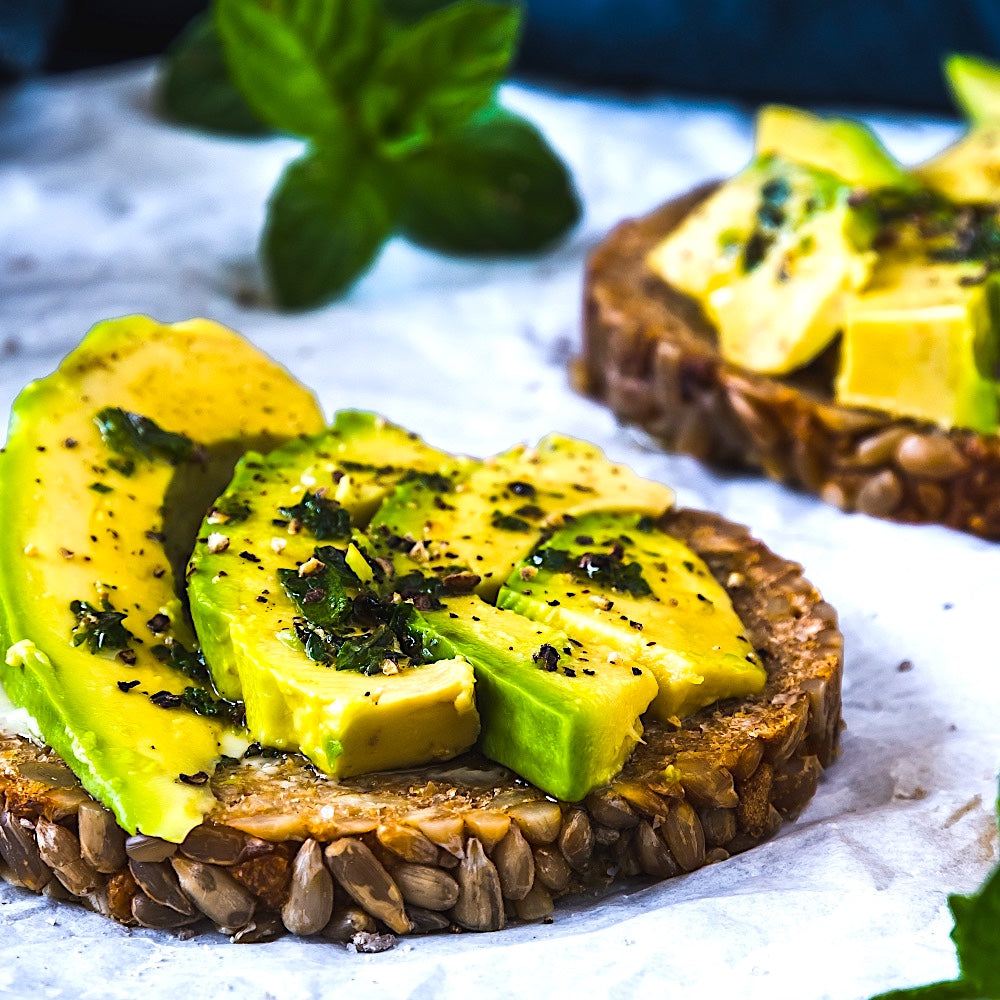 TOASTED WHOLEMEAL BREAD WITH AVOCADO, BACI KITCHEN'S LEMON-INFUSED EVOO AND HERBS